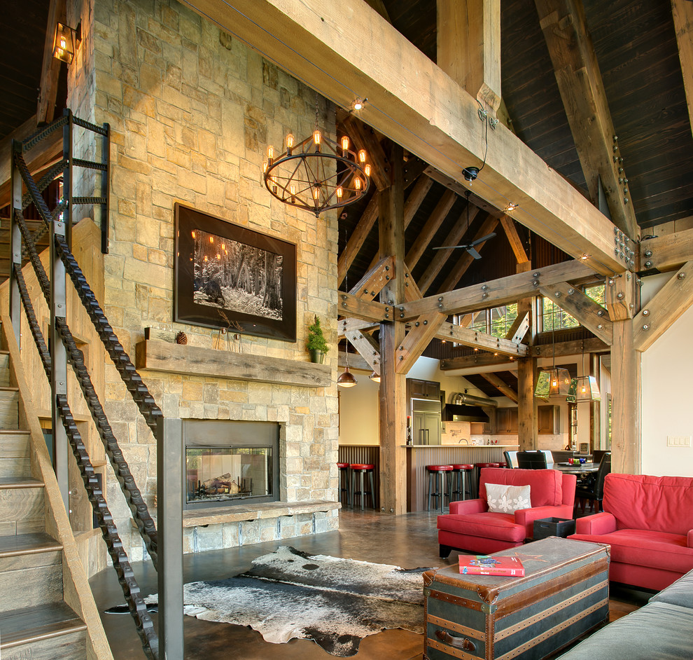 Living room - rustic open concept concrete floor and brown floor living room idea in Seattle with white walls, a two-sided fireplace and a stone fireplace