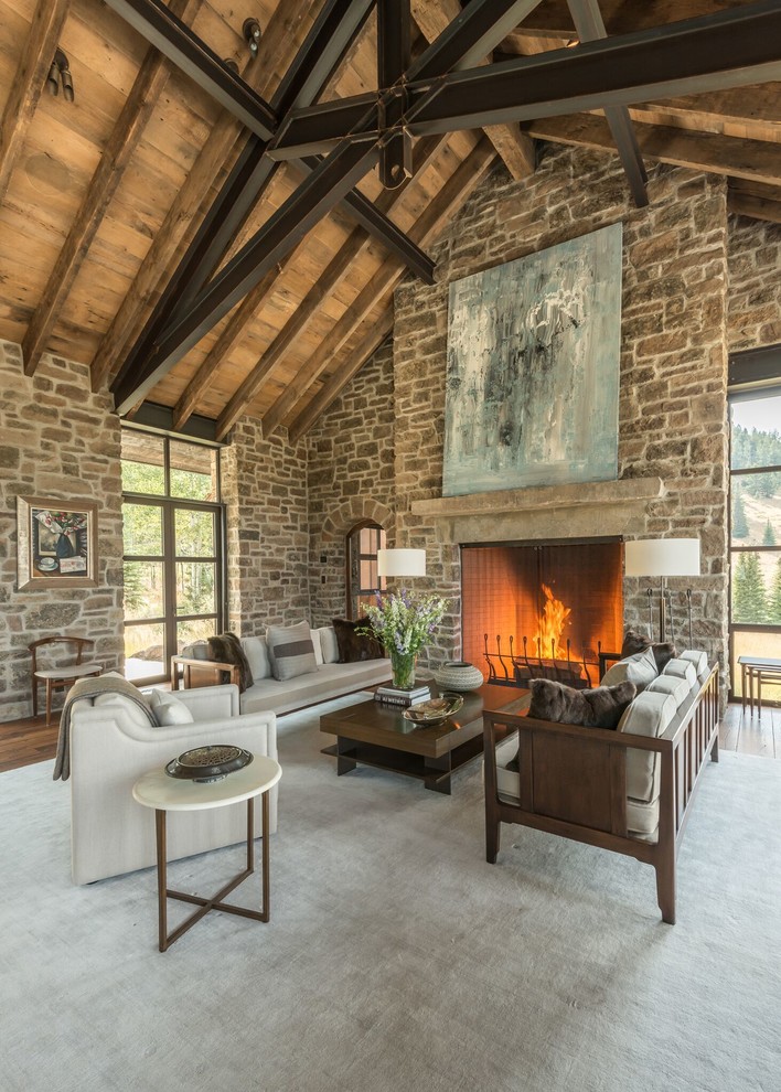 Rustic formal living room in Other with a standard fireplace and a stone fireplace surround.