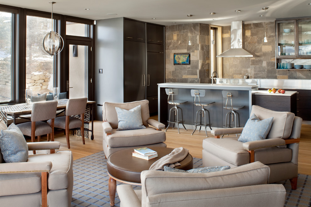 Contemporary open plan living room in Denver with light hardwood flooring.