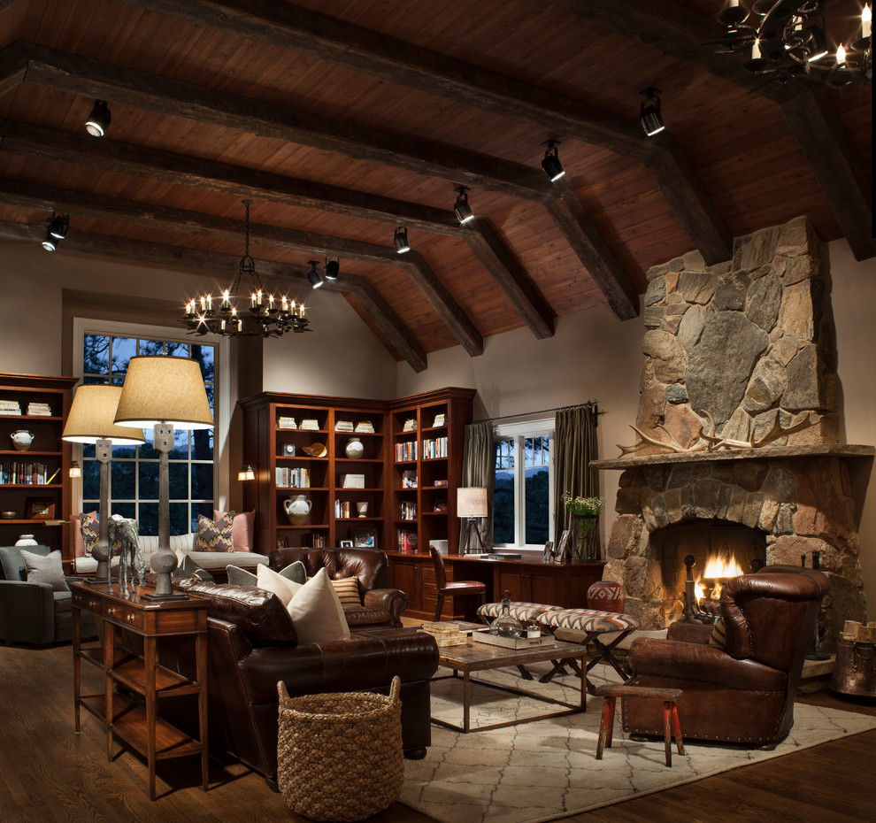 Living room library - large rustic dark wood floor living room library idea in Denver with white walls, a standard fireplace, a stone fireplace and no tv