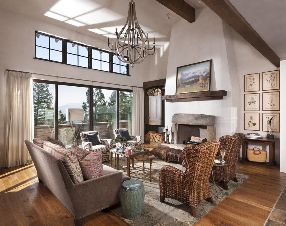 Photo of a rustic formal living room in Other with grey walls, light hardwood flooring, a standard fireplace and a stone fireplace surround.