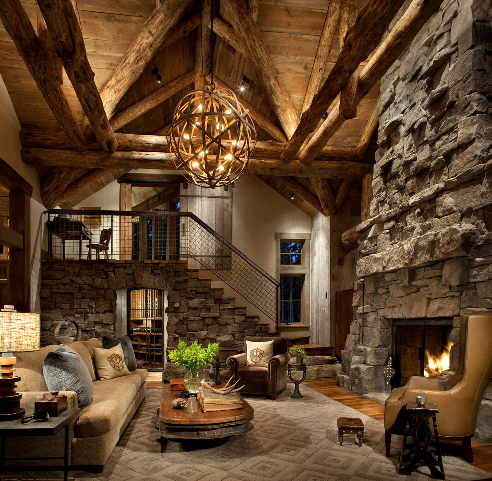This is an example of a rustic living room in Other with beige walls, dark hardwood flooring, a standard fireplace and a stone fireplace surround.