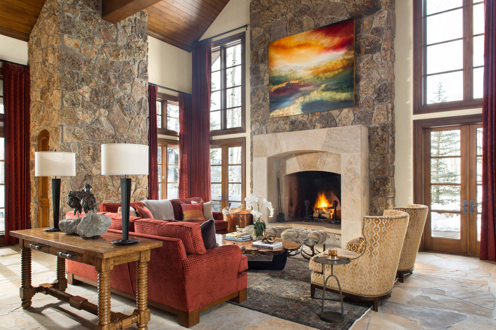 This is an example of a large traditional formal open plan living room in Denver with beige walls, a standard fireplace, a stone fireplace surround and no tv.