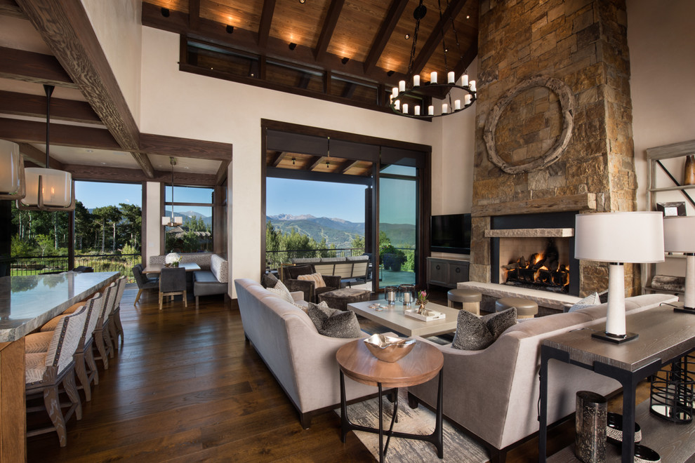 Example of a huge transitional formal and open concept medium tone wood floor and brown floor living room design in Denver with beige walls, a standard fireplace, a stone fireplace and a tv stand