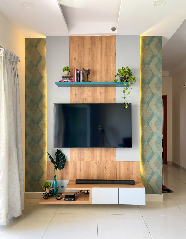 This is an example of a contemporary grey and teal living room in Bengaluru.
