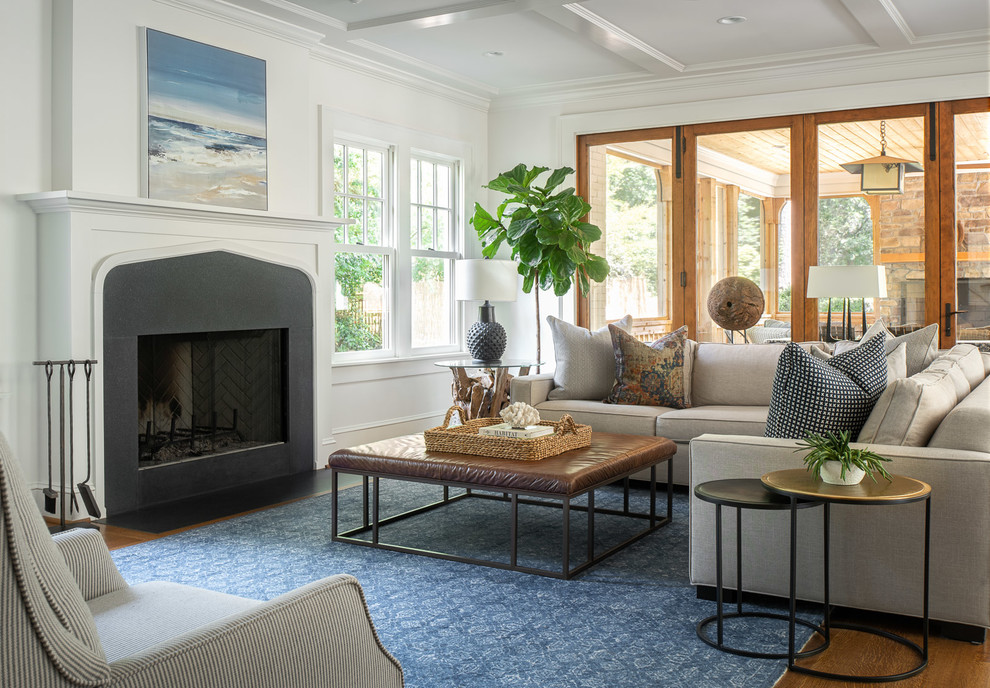 Inspiration for a large coastal formal living room in Atlanta with white walls, a standard fireplace, medium hardwood flooring, no tv and feature lighting.
