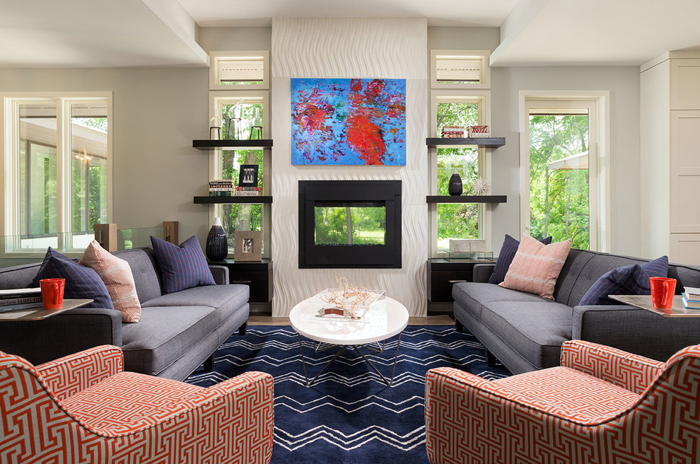 Living room - transitional formal and open concept medium tone wood floor living room idea in Minneapolis with gray walls, a two-sided fireplace and a metal fireplace