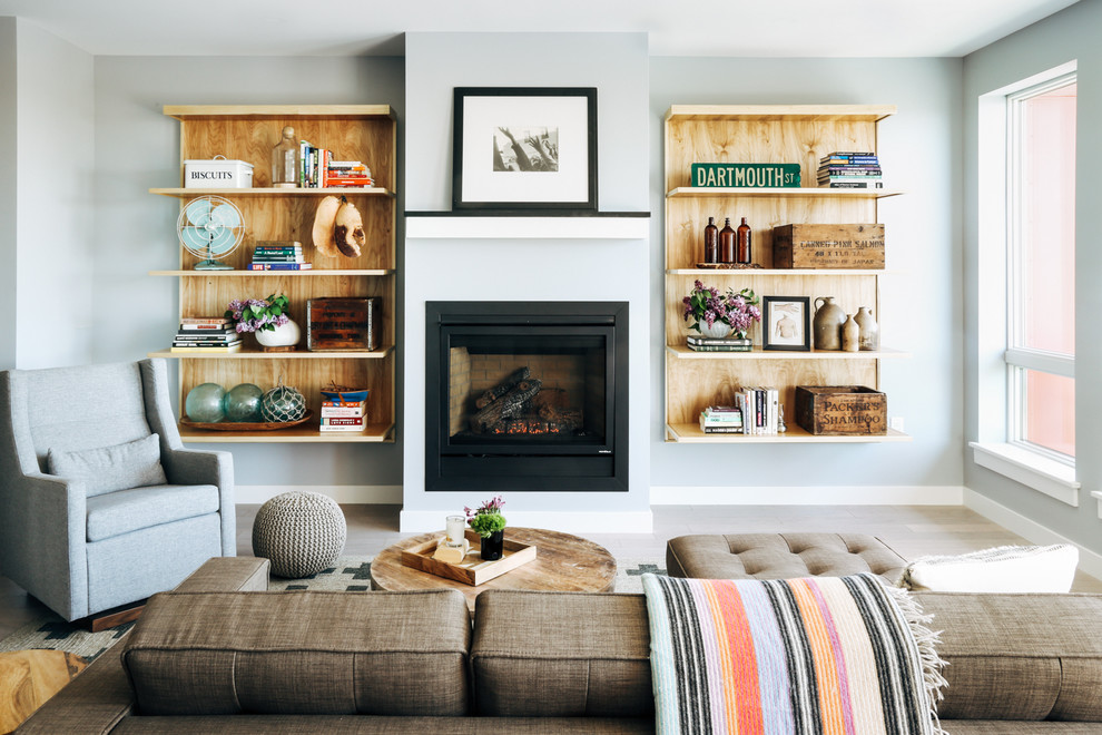 Mid-sized elegant formal and open concept laminate floor and gray floor living room photo in Portland Maine with gray walls, a standard fireplace, a metal fireplace and no tv