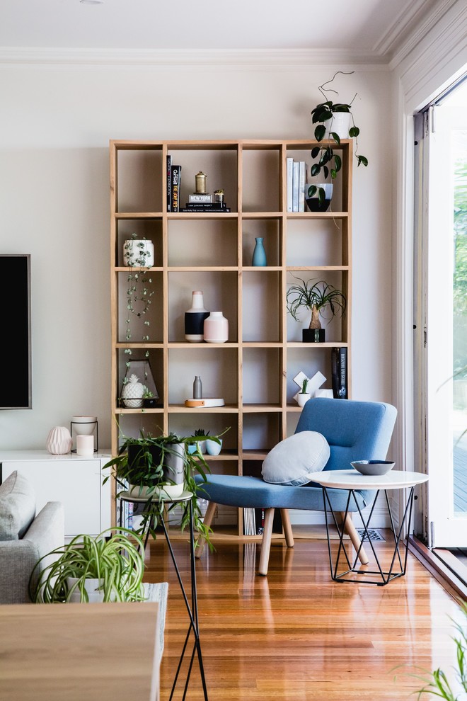 Living room - scandinavian light wood floor living room idea in Melbourne with white walls and a wall-mounted tv