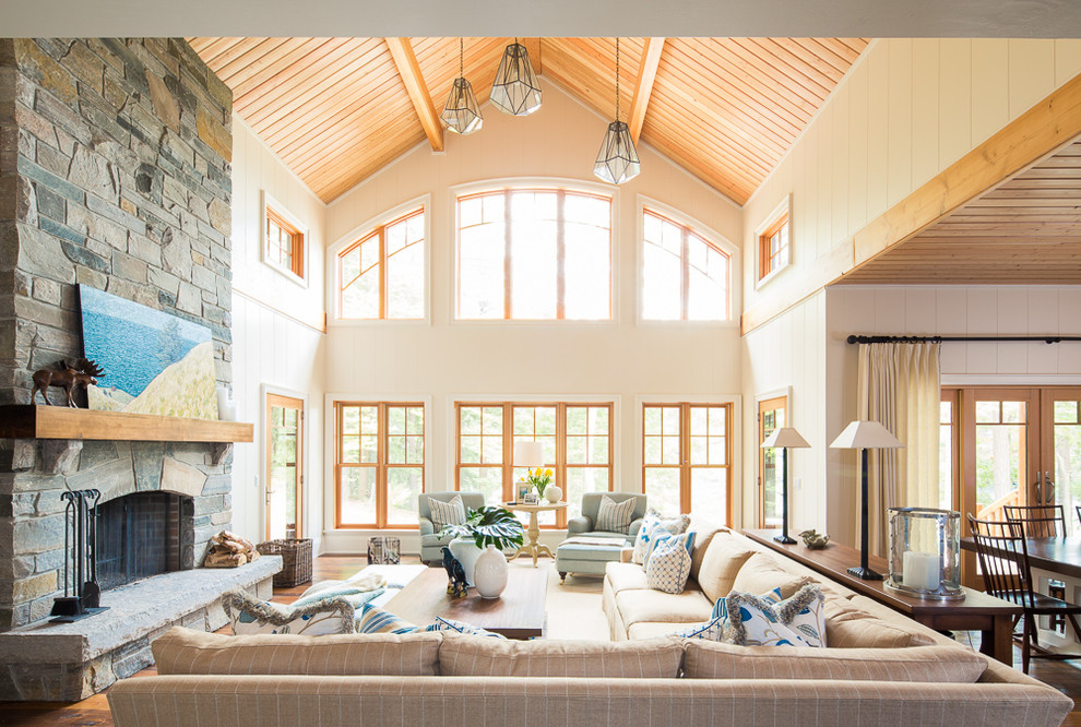 Inspiration for a beach style open plan living room in Toronto with beige walls, dark hardwood flooring, a standard fireplace, a stone fireplace surround, no tv and brown floors.