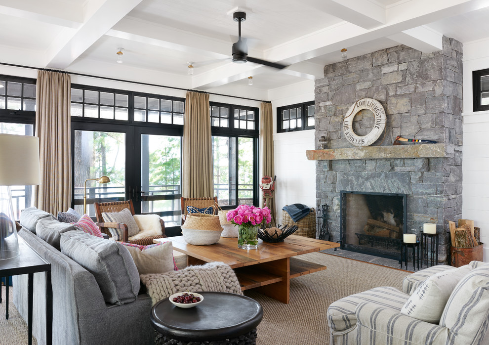 Living room - coastal carpeted and beige floor living room idea in Toronto with white walls, a standard fireplace and a stone fireplace