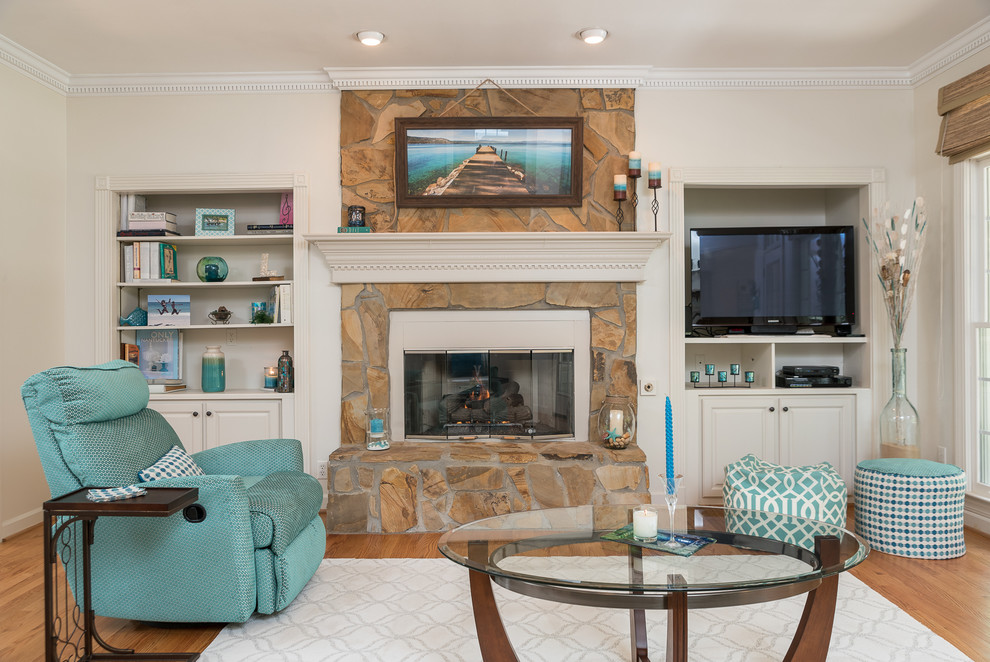 Inspiration for a mid-sized transitional open concept medium tone wood floor living room remodel in Other with a bar, beige walls, a standard fireplace, a stone fireplace and a media wall