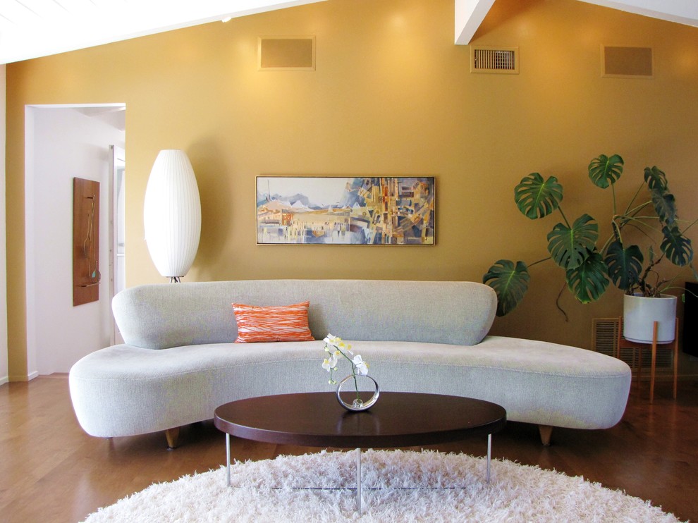 Inspiration for a mid-century modern living room remodel in Orange County with yellow walls