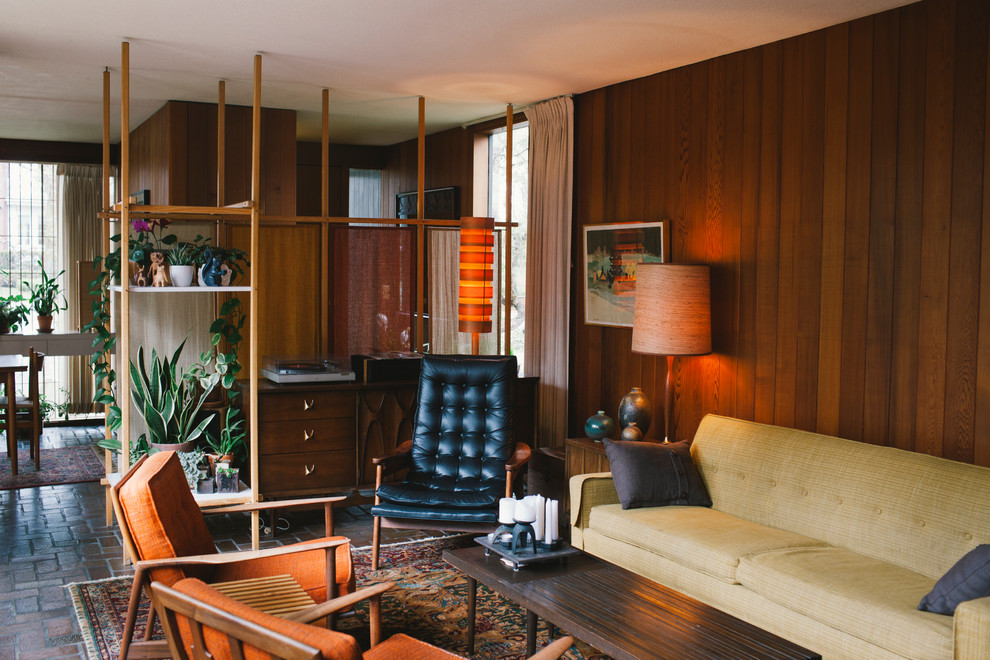 На фото: парадная, изолированная гостиная комната среднего размера в стиле ретро с коричневыми стенами, полом из терракотовой плитки, стандартным камином и фасадом камина из кирпича без телевизора с