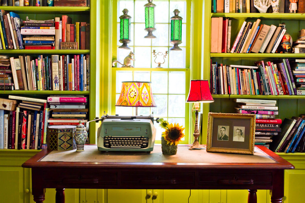 Living room library - cottage living room library idea in New York with green walls