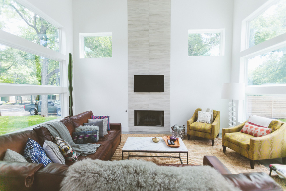 Example of a trendy living room design in Austin with white walls, a standard fireplace, a tile fireplace and a wall-mounted tv