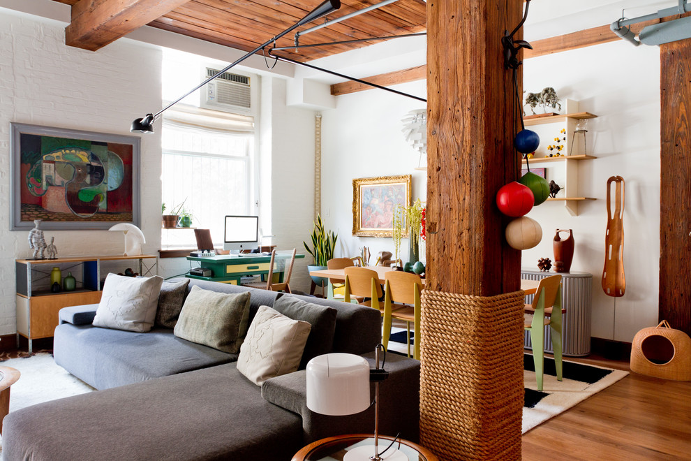 Living room - eclectic open concept living room idea in New York with white walls