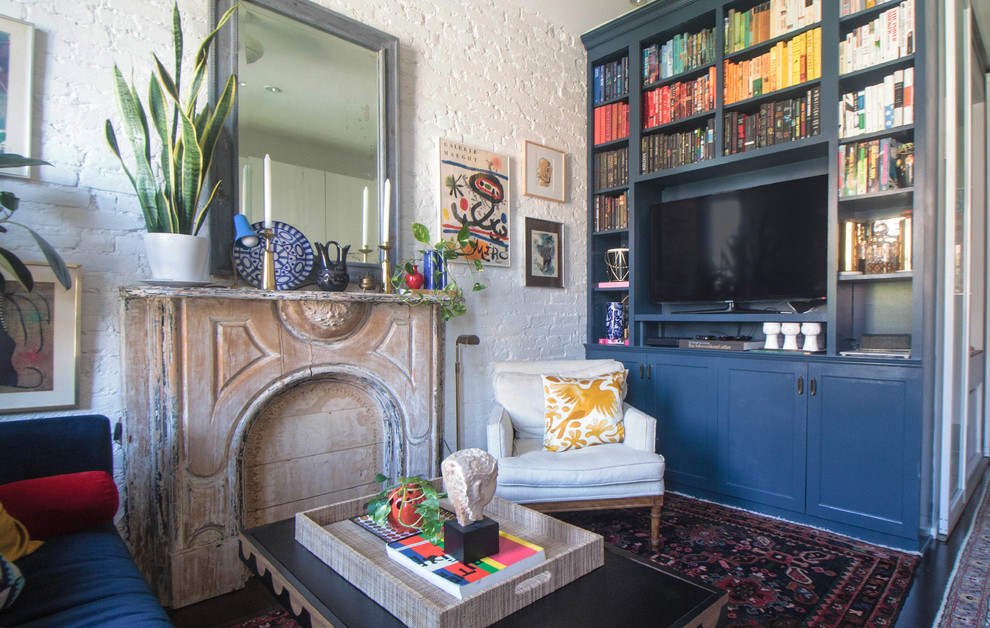 Living room library - eclectic dark wood floor living room library idea in New York with white walls and a media wall