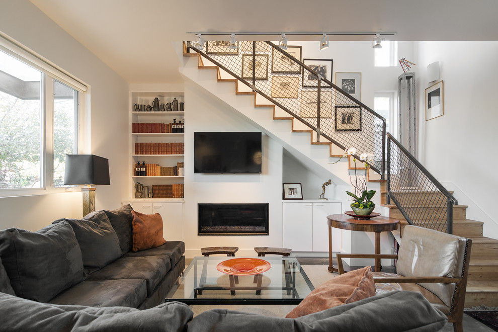Inspiration for a contemporary living room remodel in Salt Lake City with a ribbon fireplace, a plaster fireplace, a wall-mounted tv and white walls