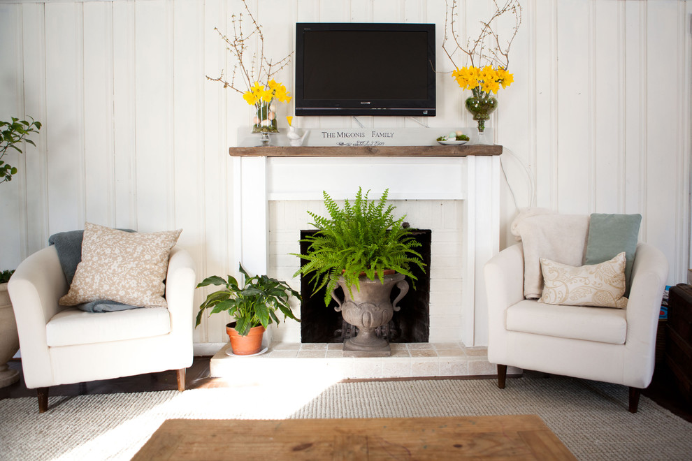Living room - traditional living room idea in Boston with a standard fireplace and a wall-mounted tv