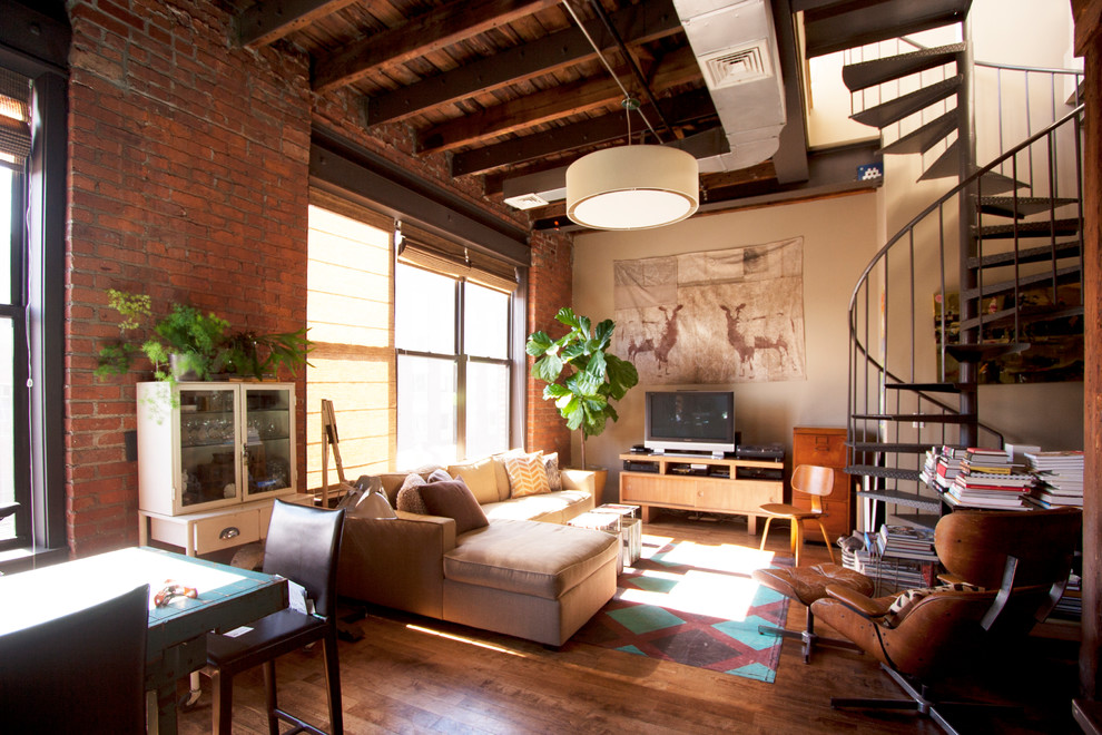 Example of an urban living room design in New York with beige walls and a tv stand