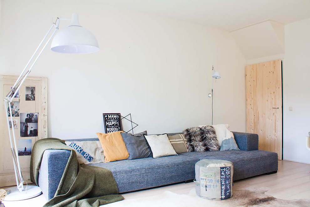 Living room - eclectic living room idea in Amsterdam with white walls and no fireplace