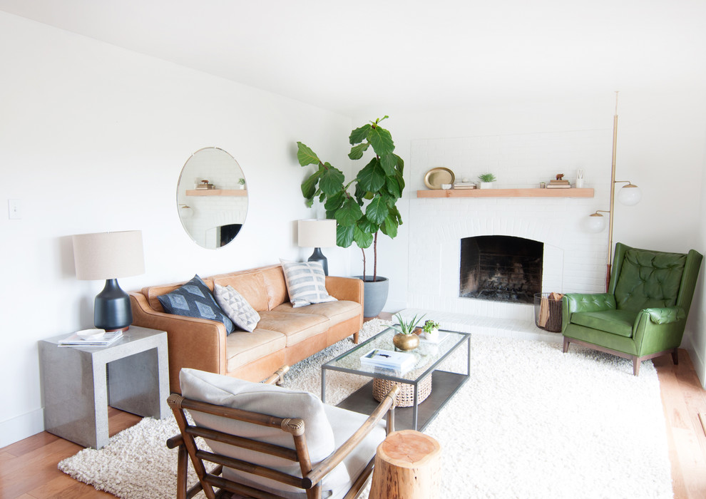 Inspiration for a medium sized retro open plan living room in Denver with white walls, light hardwood flooring, a standard fireplace, no tv and feature lighting.