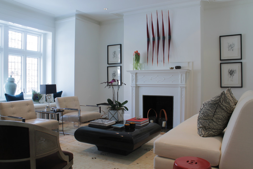This is an example of a contemporary living room in Montreal with white walls and a standard fireplace.