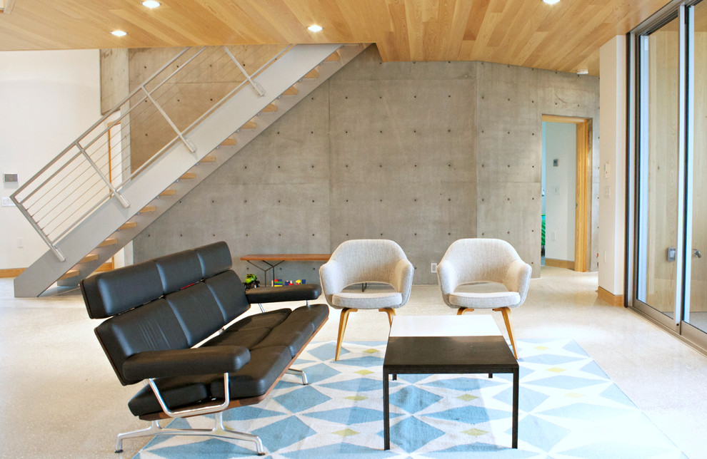 Cette image montre un salon design ouvert avec une salle de réception, un mur blanc, sol en béton ciré, aucune cheminée, aucun téléviseur et un escalier.