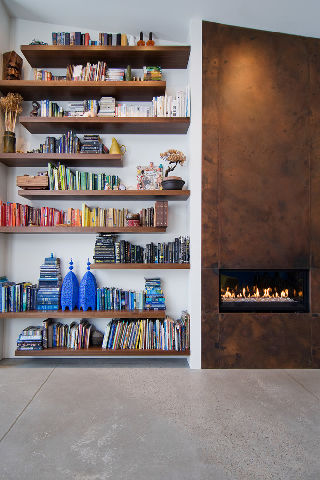 Inspiration for a contemporary living room in Salt Lake City with concrete flooring and a metal fireplace surround.