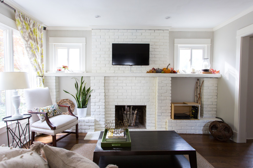 Photo of a medium sized classic open plan living room in Kansas City with a standard fireplace, a brick fireplace surround and a wall mounted tv.