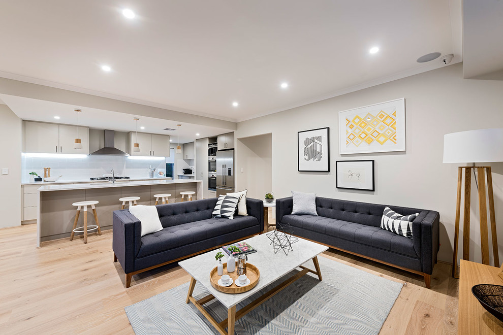 Danish open concept light wood floor living room photo in Perth with gray walls