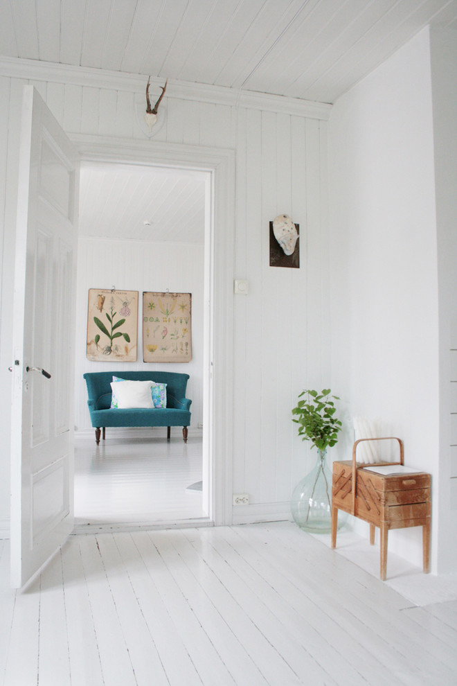 Living room - scandinavian painted wood floor and white floor living room idea in Other with white walls