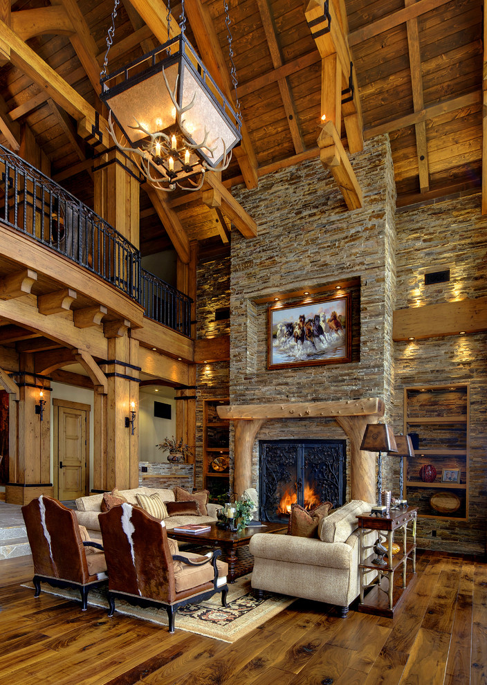 Design ideas for a large rustic enclosed living room in Other with a stone fireplace surround, beige walls and dark hardwood flooring.