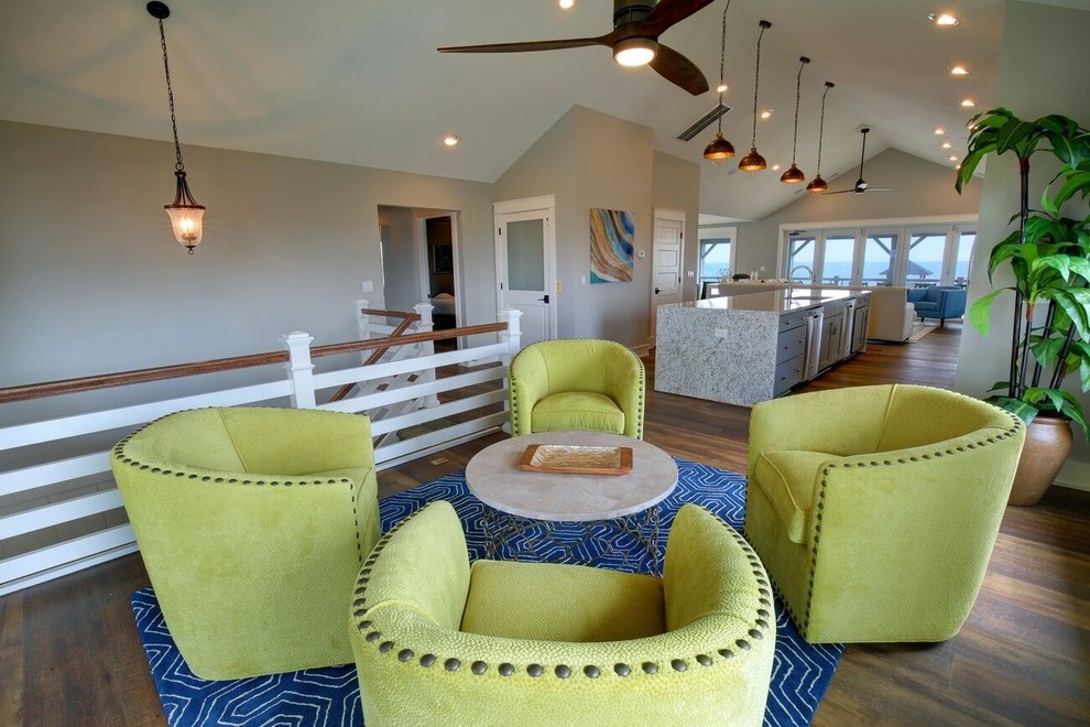 Cette image montre un salon marin de taille moyenne et ouvert avec une salle de réception, un mur beige, parquet foncé, une cheminée standard, un manteau de cheminée en carrelage et un sol marron.