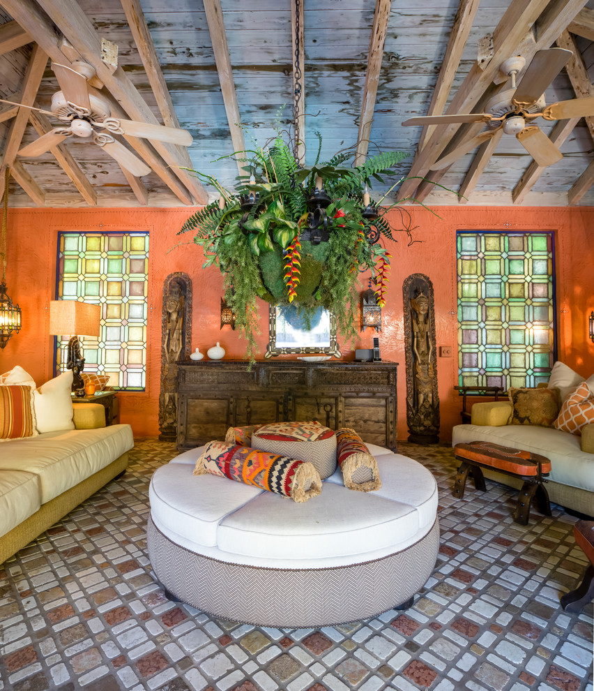 Large mediterranean living room in Miami with terracotta flooring, orange walls and multi-coloured floors.