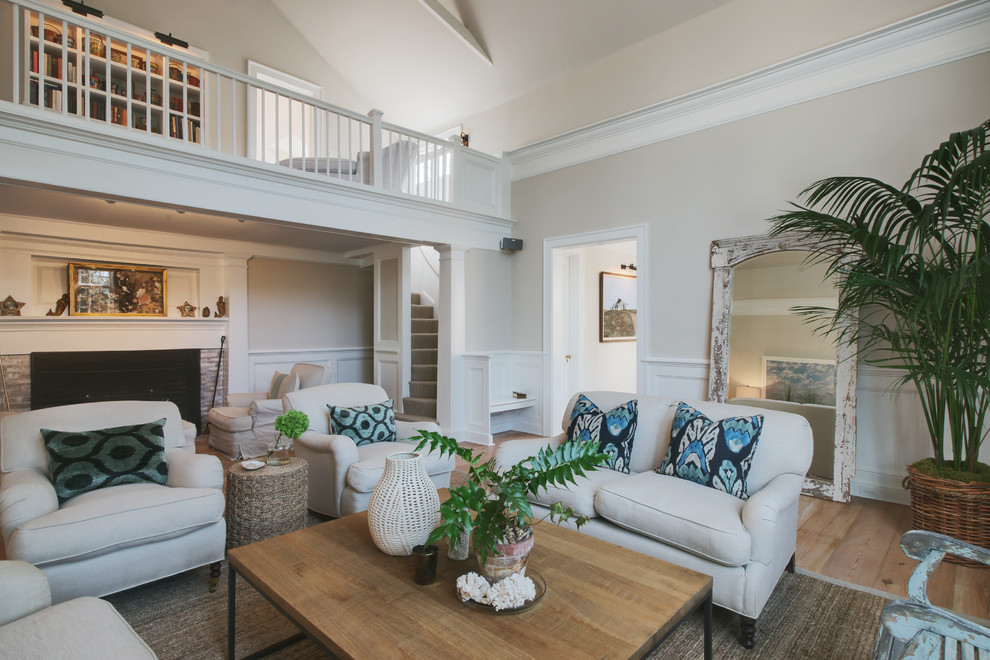 Inspiration for a medium sized beach style formal enclosed living room in Boston with beige walls, light hardwood flooring, a standard fireplace, a brick fireplace surround and no tv.