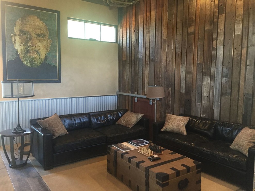 Photo of a large industrial living room in San Francisco with brown walls and concrete flooring.