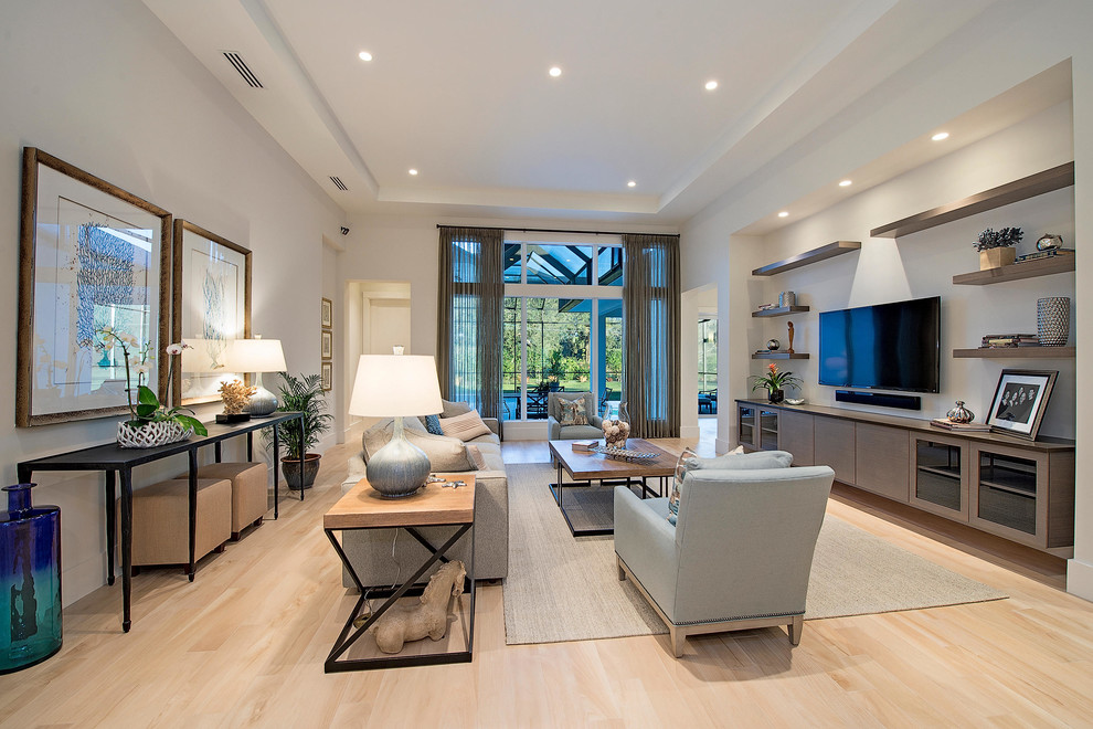 Example of a large transitional open concept living room design in Miami with white walls and a wall-mounted tv