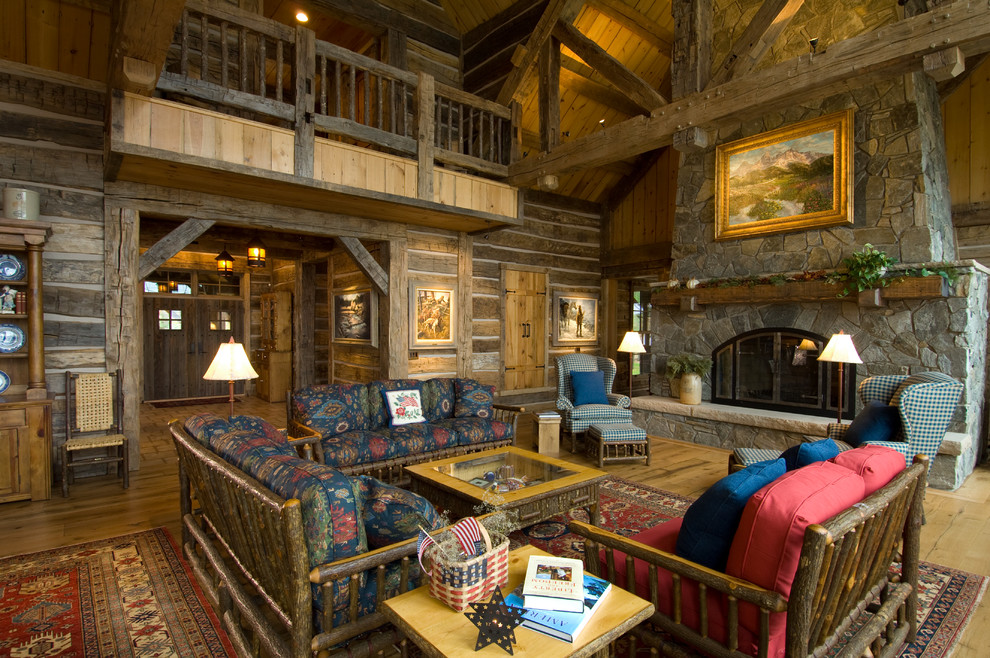 Cette photo montre un salon montagne ouvert avec une salle de réception, un mur marron, parquet clair, une cheminée standard et un manteau de cheminée en pierre.