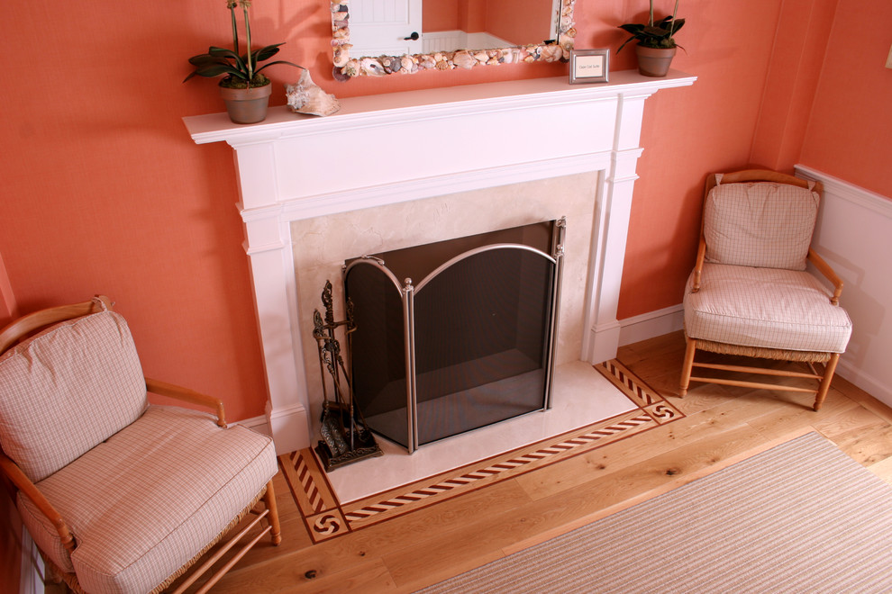 Example of a mid-sized beach style formal and enclosed light wood floor living room design in Boston with pink walls, a standard fireplace, a tile fireplace and no tv