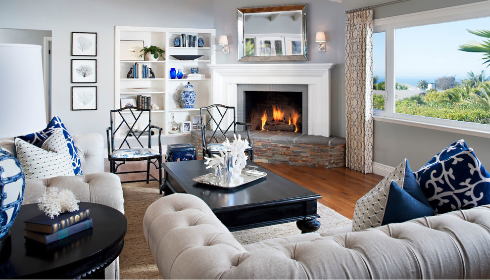 Living room - mid-sized traditional formal and open concept medium tone wood floor living room idea in San Diego with gray walls, a standard fireplace, a stone fireplace and no tv