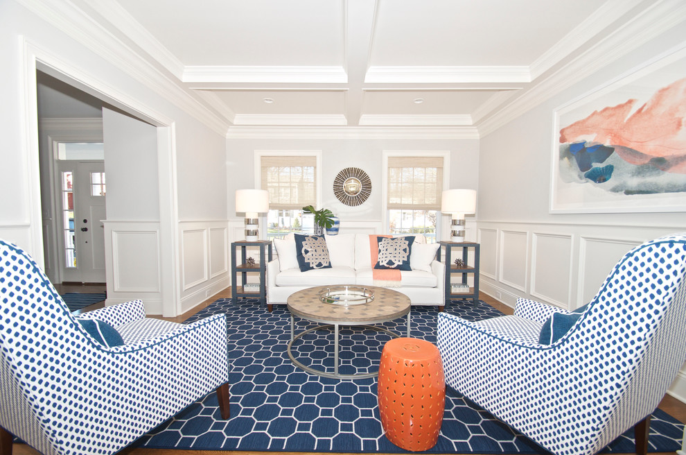 На фото: открытая, парадная гостиная комната среднего размера в стиле неоклассика (современная классика) с серыми стенами, ковровым покрытием и синим полом без камина, телевизора с
