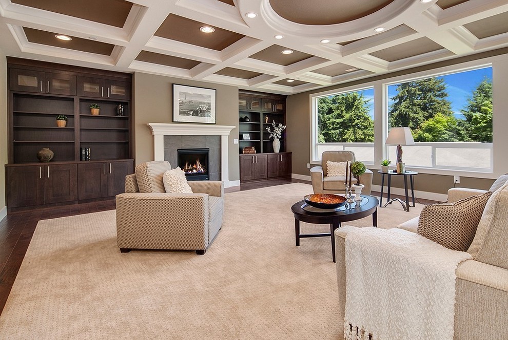 Large classic formal open plan living room in Seattle with brown walls, dark hardwood flooring, a standard fireplace, a tiled fireplace surround, no tv and brown floors.