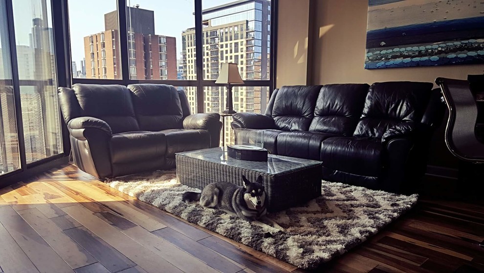 Imagen de salón abierto moderno de tamaño medio con paredes grises, suelo de madera en tonos medios, chimenea de doble cara, televisor independiente y suelo multicolor