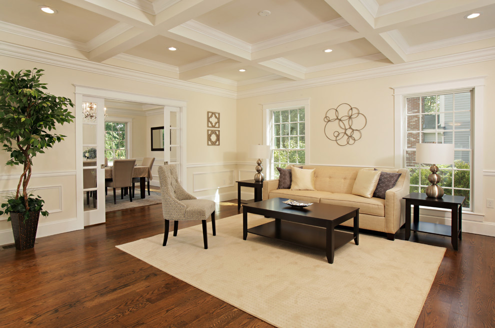 Large traditional living room in Boston with yellow walls and medium hardwood flooring.