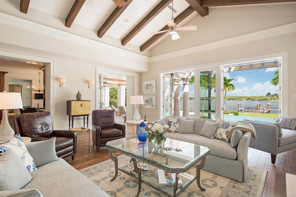 Photo of a beach style living room in Miami with beige walls and dark hardwood flooring.
