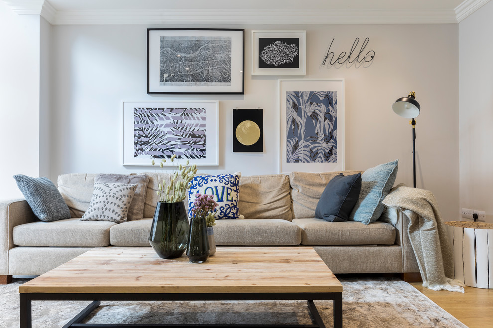 Living room - transitional formal and enclosed medium tone wood floor and beige floor living room idea in London with gray walls
