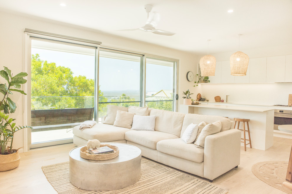 Großes, Offenes Modernes Wohnzimmer mit weißer Wandfarbe und hellem Holzboden in Sunshine Coast