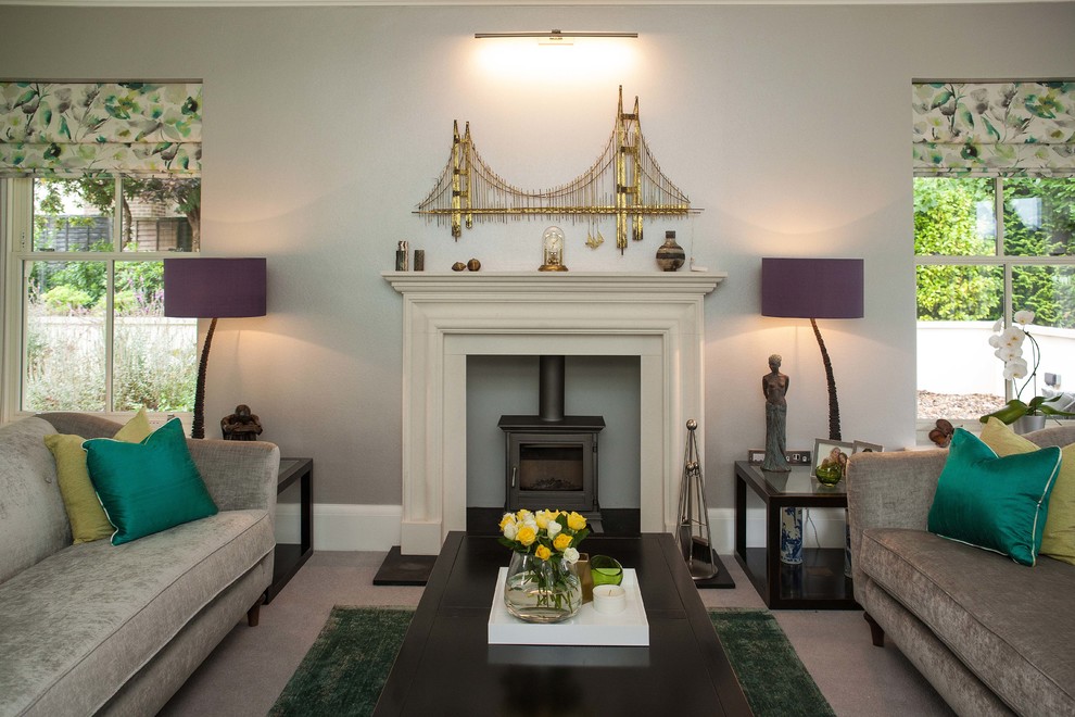Design ideas for a large classic formal enclosed living room in Surrey with multi-coloured walls, carpet, a standard fireplace, a stone fireplace surround, no tv and grey floors.